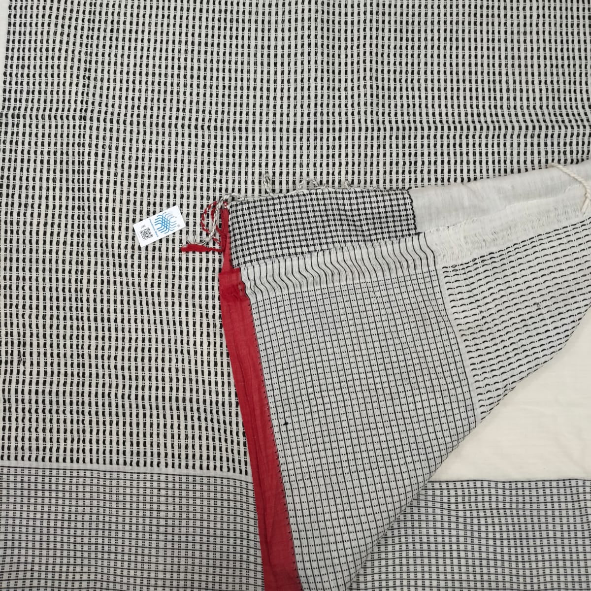Handloom tagged ivory colour cotton.