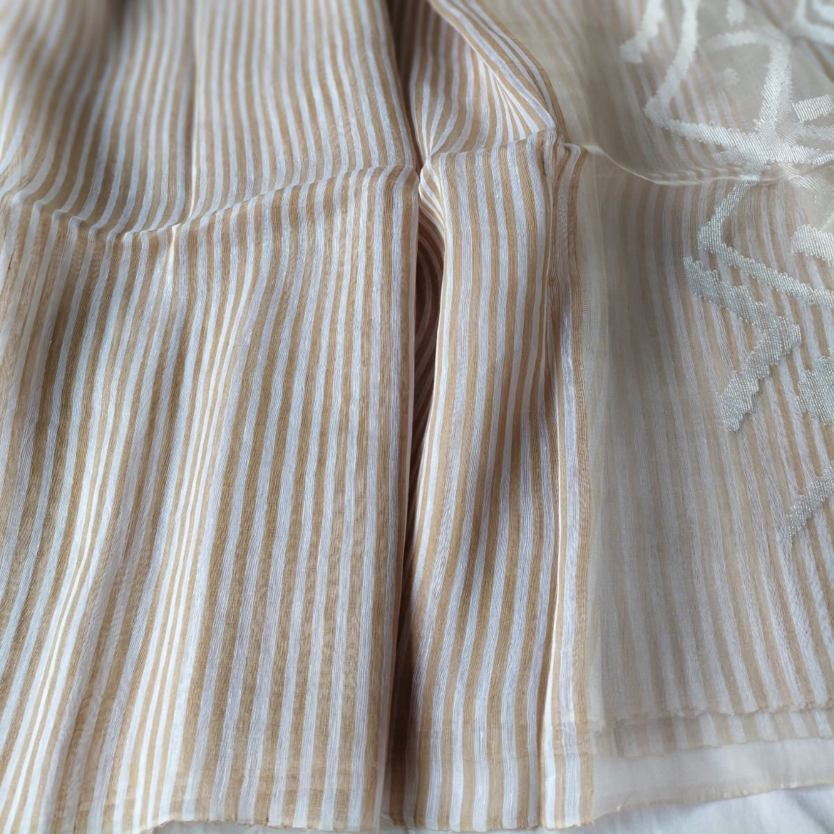 Handwoven beige and white striped silk linen saree with pure muslin palla with intricate jamdani work. Perfect for special occasions and celebrations. 