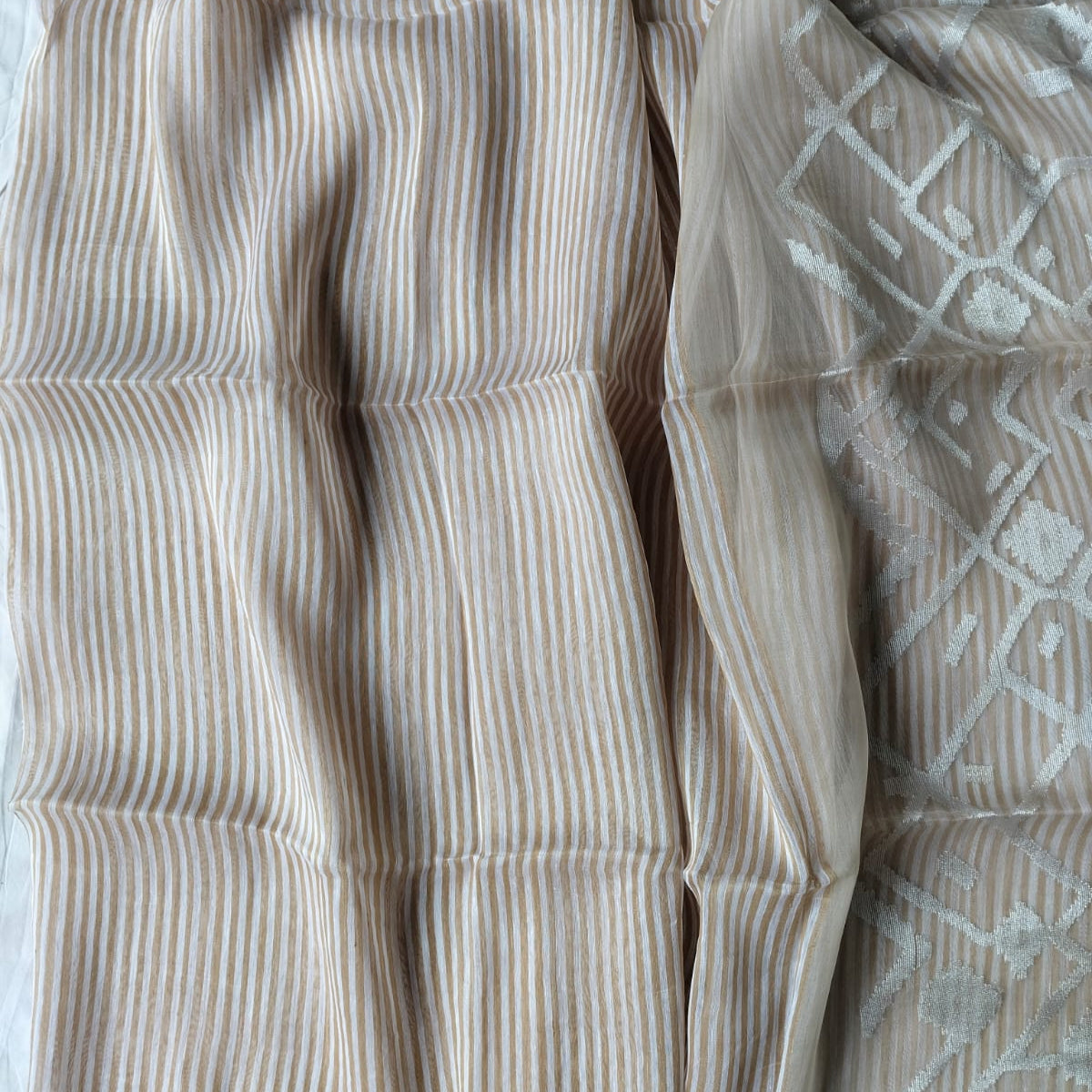 Handwoven beige and white striped silk linen saree with pure muslin palla with intricate jamdani work. Perfect for special occasions and celebrations. 