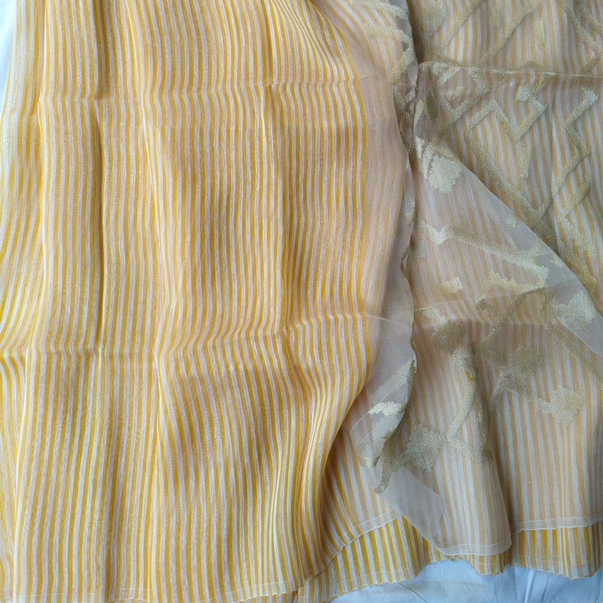 Handwoven yellow and white striped silk linen saree with pure muslin palla with intricate jamdani work. Perfect for special occasions and celebrations. 