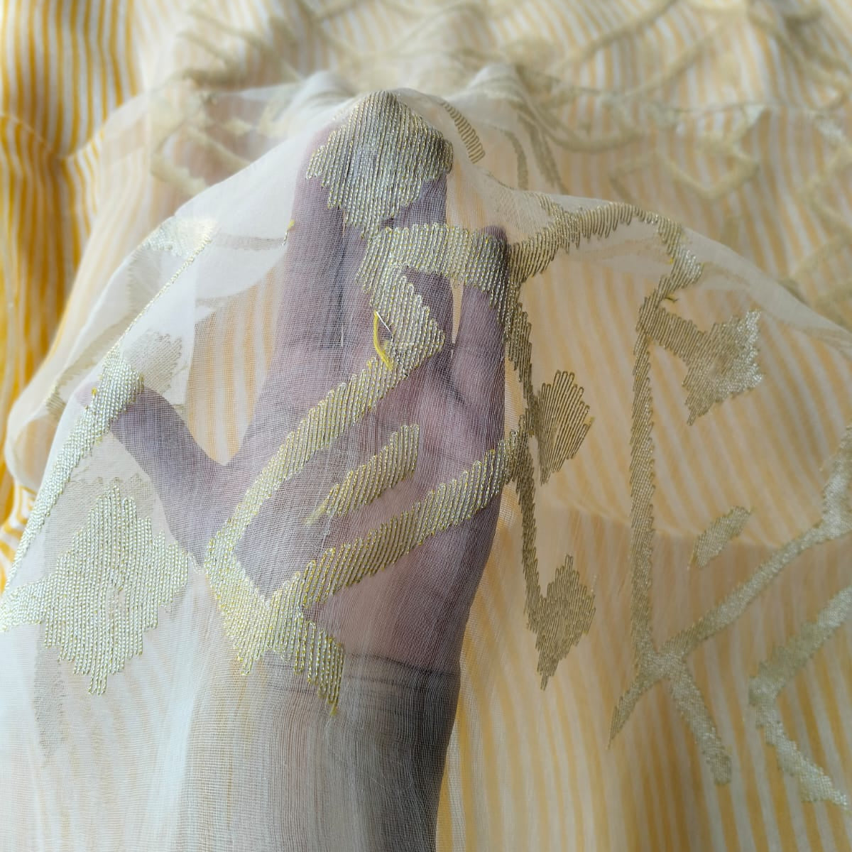 Handwoven yellow and white striped silk linen saree with pure muslin palla with intricate jamdani work. Perfect for special occasions and celebrations. 