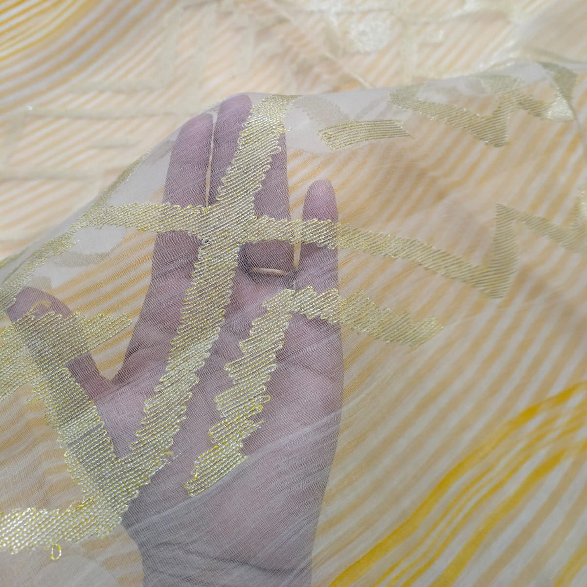 Handwoven yellow and white striped silk linen saree with pure muslin palla with intricate jamdani work. Perfect for special occasions and celebrations. 