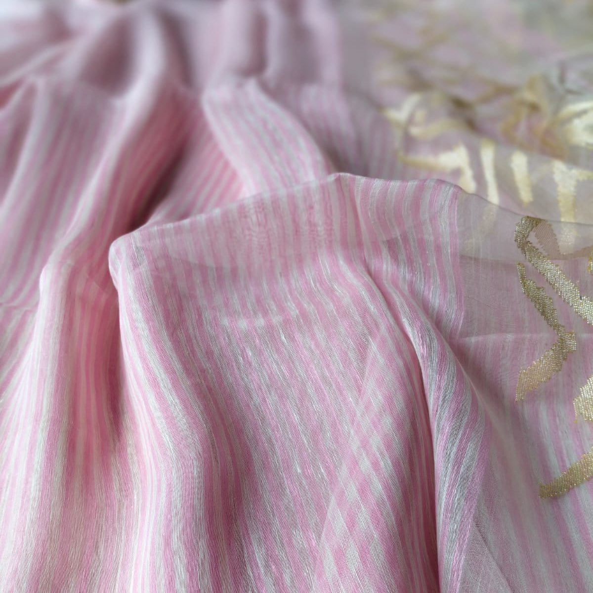 Handwoven pink and white striped silk linen saree with pure muslin palla with intricate jamdani work. Perfect for special occasions and celebrations. 