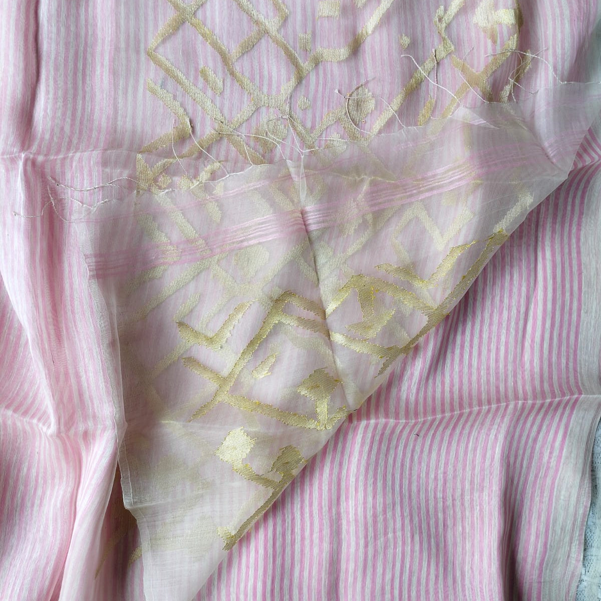 Handwoven pink and white striped silk linen saree with pure muslin palla with intricate jamdani work. Perfect for special occasions and celebrations. 